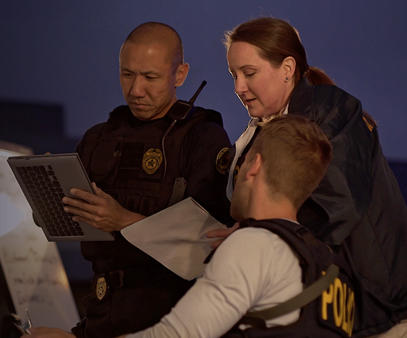 Three US Postal Inspectors taking notes