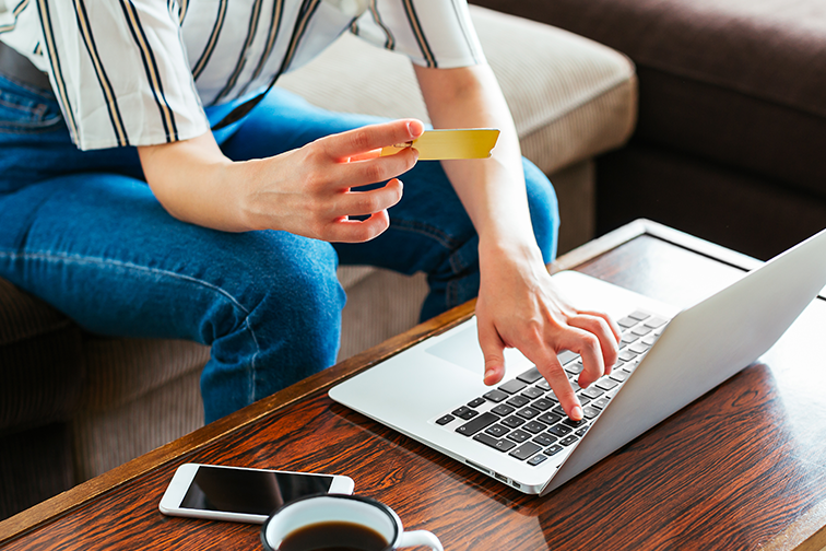 Woman shopping online using a laptop